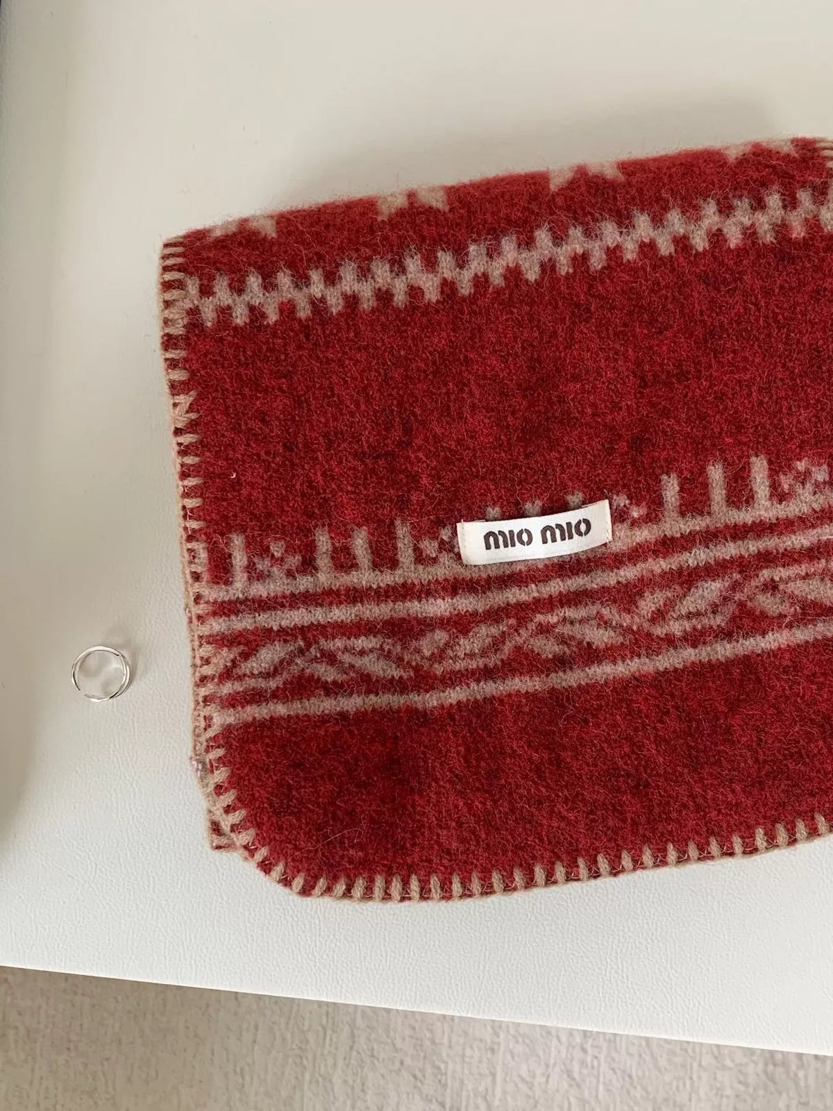 Unisex Vintage Pattern Knitted Scarf — folded rust scarf displaying decorative end panel