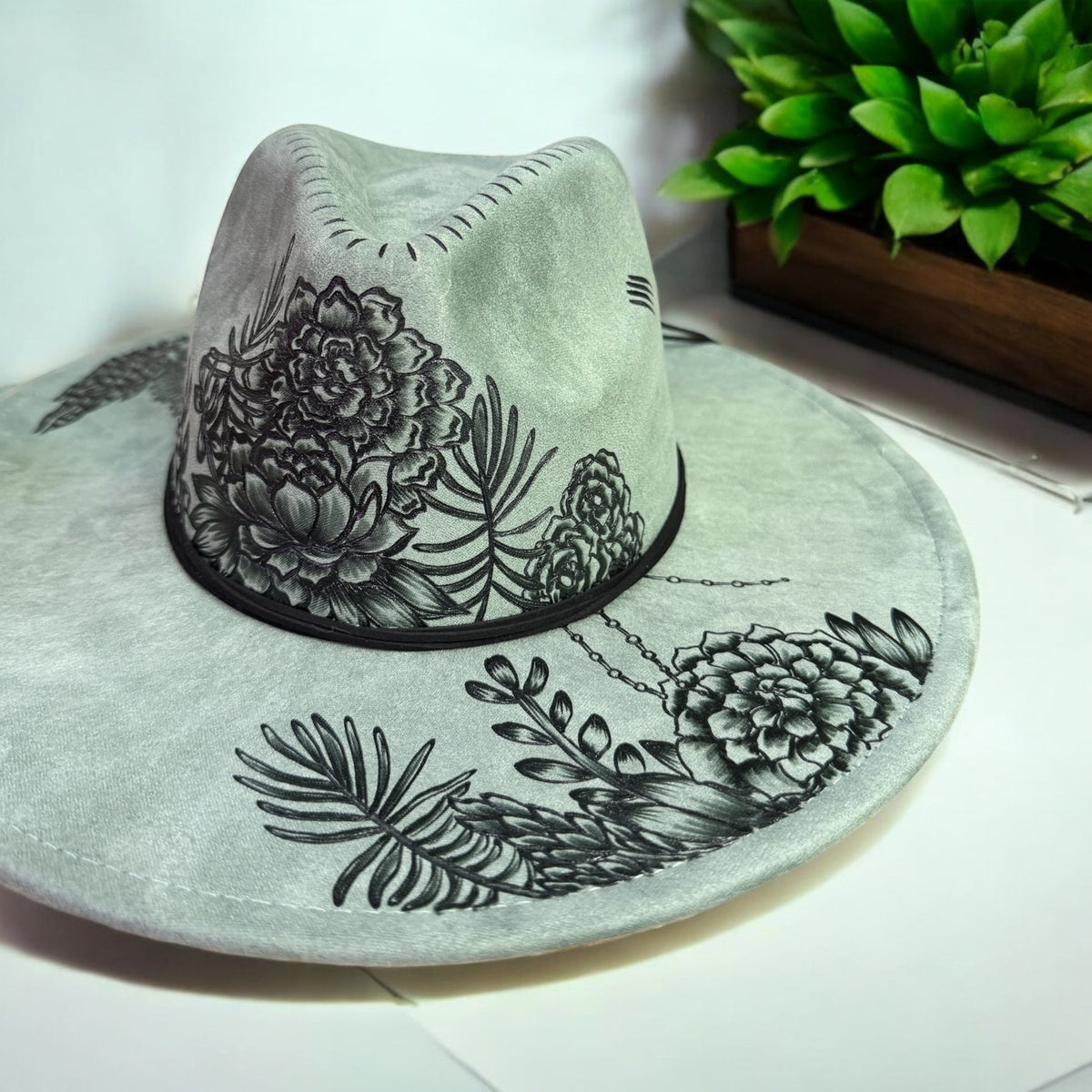 Front angled view of the Piper Jade hat showing burned foliage and a decorative band