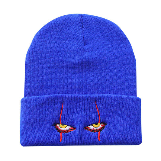 Blue knit beanie with narrow eyes and red embroidery