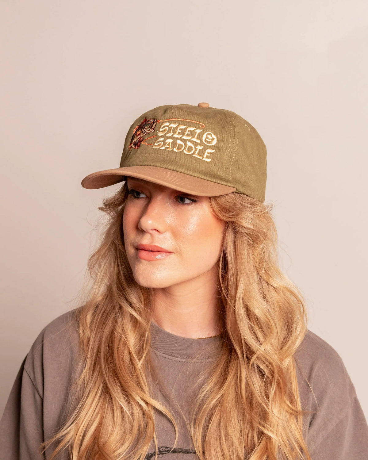Front view of a model wearing the Steel & Saddle Bass Hat