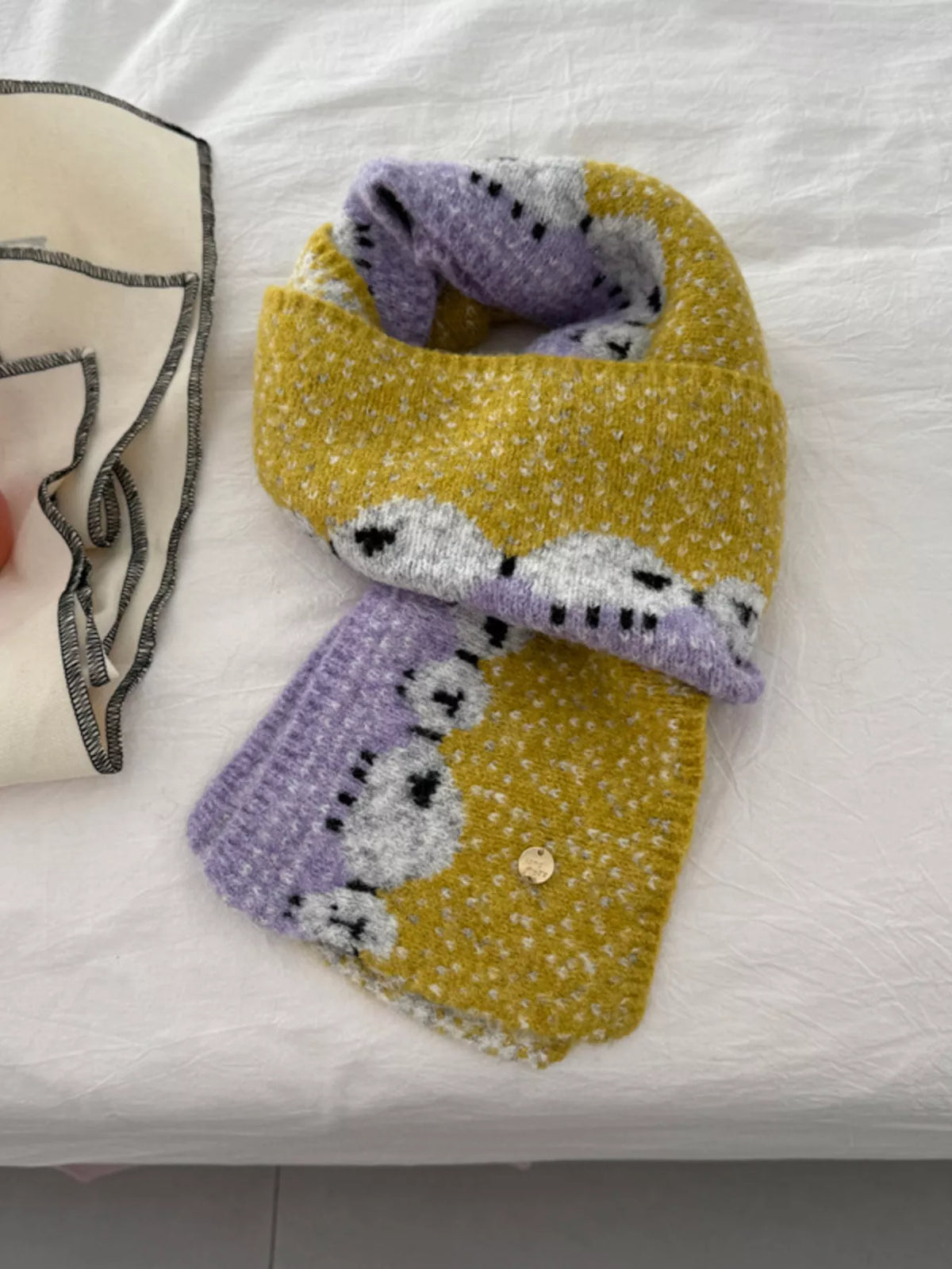 Unisex Sheep Motif Knit Scarf — yellow sheep scarf loosely tied with patterned ends forward