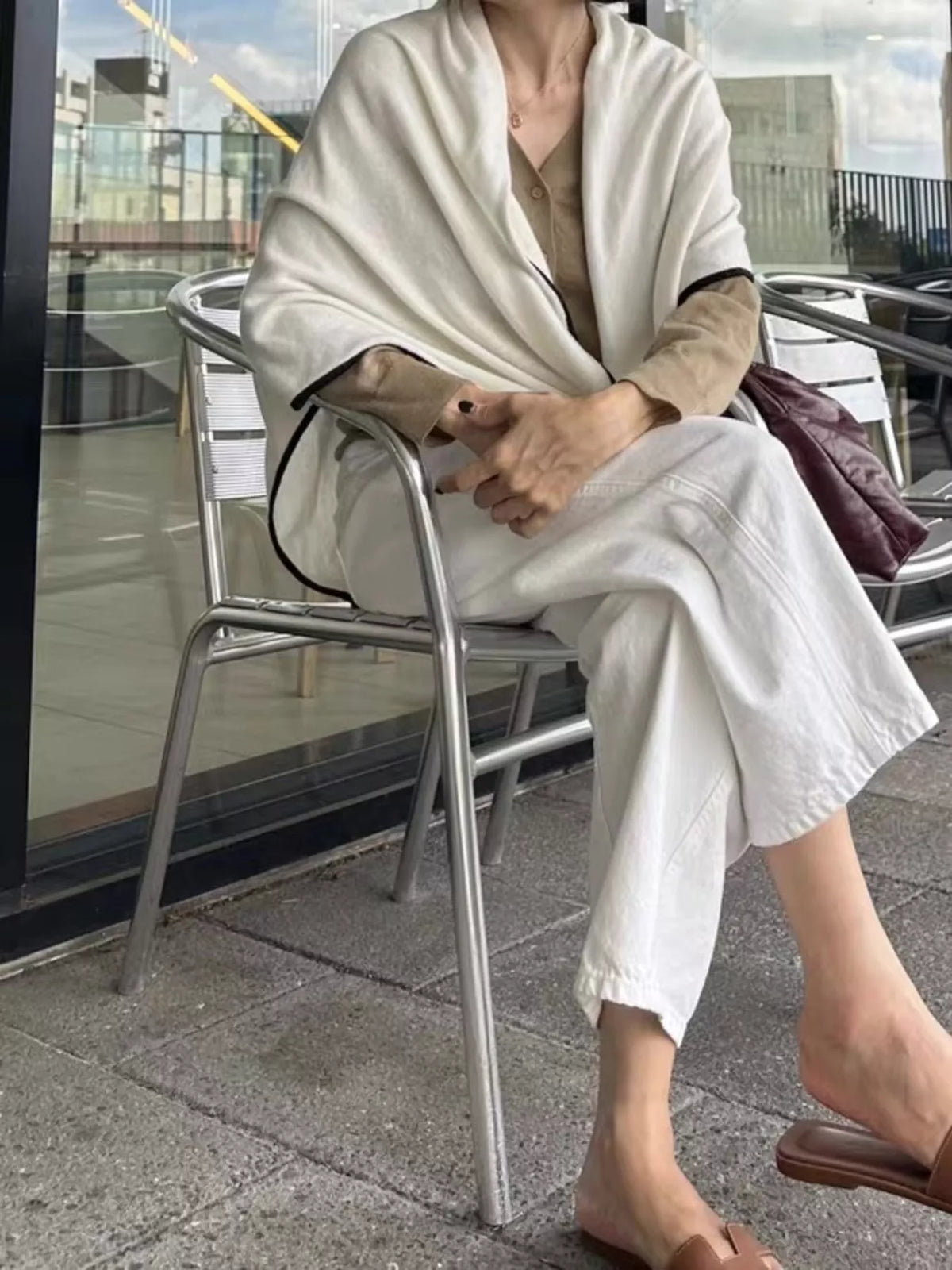 Unisex 100% Wool Contrast Trim Scarf — contrast trim scarf worn with a seated neutral outfit