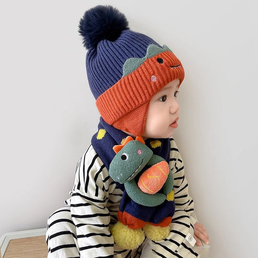 Child modeling the navy orange beanie and dinosaur scarf set