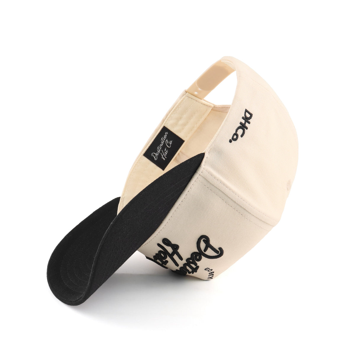 Interior view of the Destination Hat Co. Destination script cap showing the inner band and underside of the bill