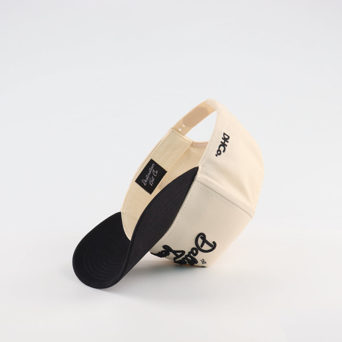 Interior view of the Destination Hat Co. Dallas script cap showing the inner band and underside of the bill
