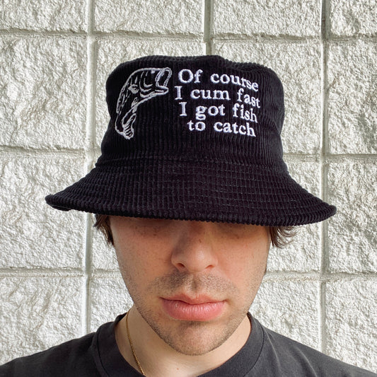 Front view of a model wearing the black Of Course Embroidered Bucket Hat