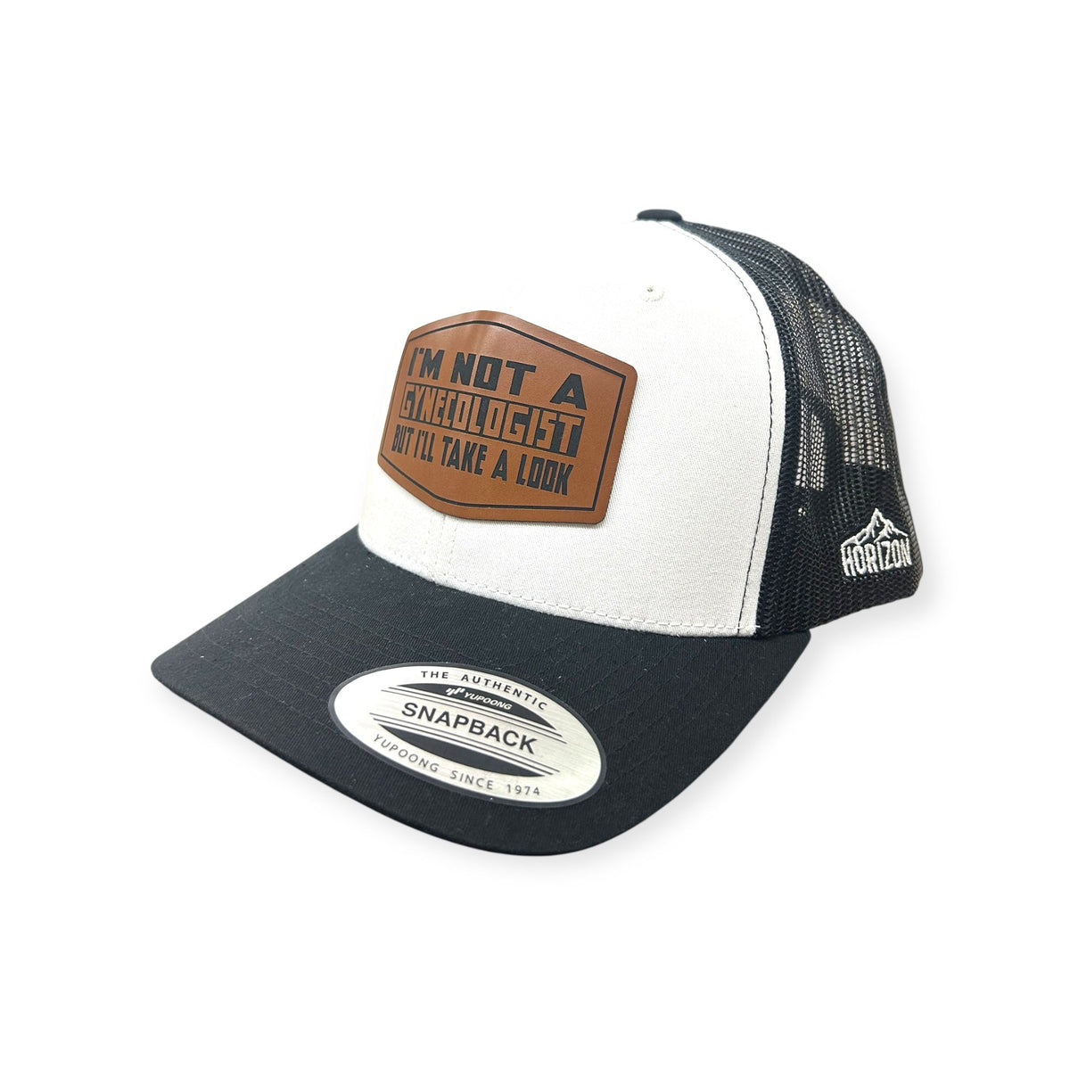 Angled view of Not A Gynecologist patch hat by Horizon Hat Co. in white/black showing the curved bill and side panels