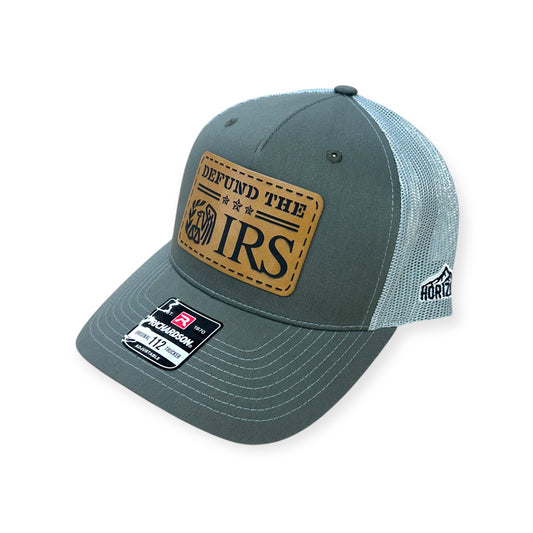 Angled view of Defund the IRS patch hat by Horizon Hat Co. in beetle/quarry showing the curved bill and side panels