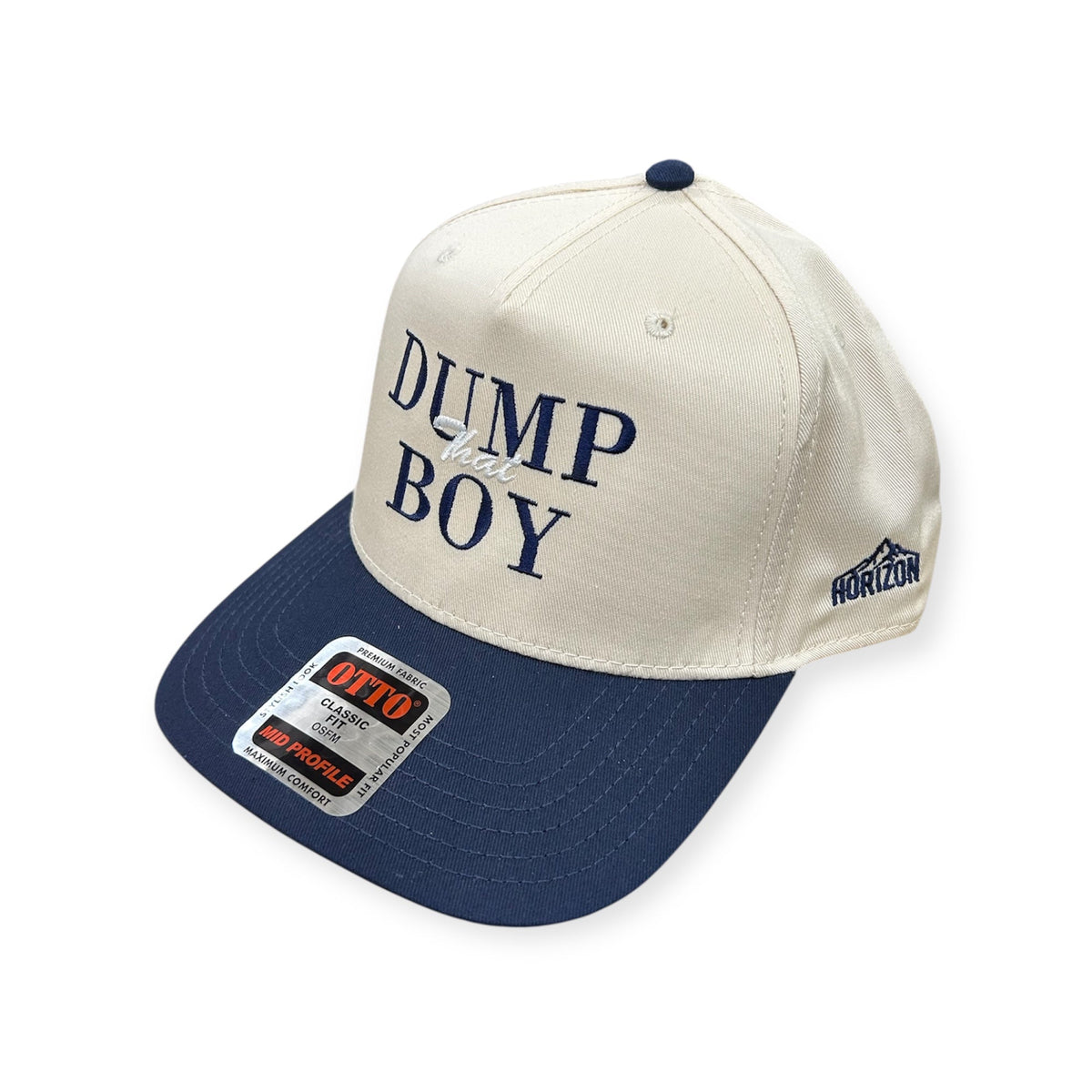 Angled view of Dump That Boy embroidered cap by Horizon Hat Co. in natural/navy showing the bill and side panels