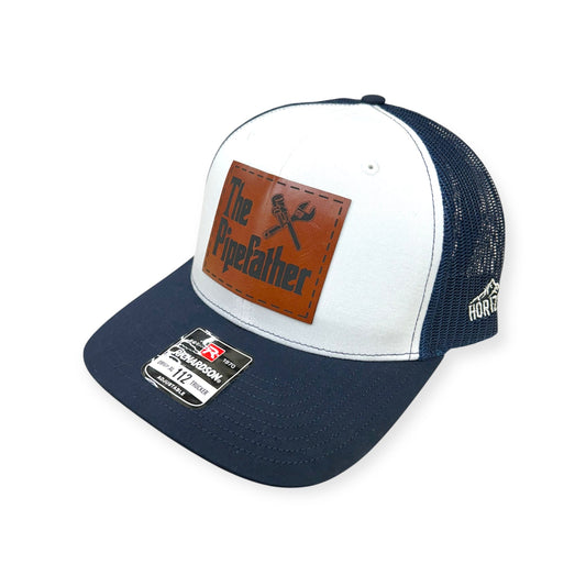 Angled view of The Pipefather patch hat by Horizon Hat Co. in navy/white/navy showing the curved bill and side panels