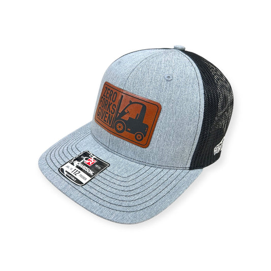 Angled view of Zero Forks Given patch hat by Horizon Hat Co. in heather gray/black showing the curved bill and side panels
