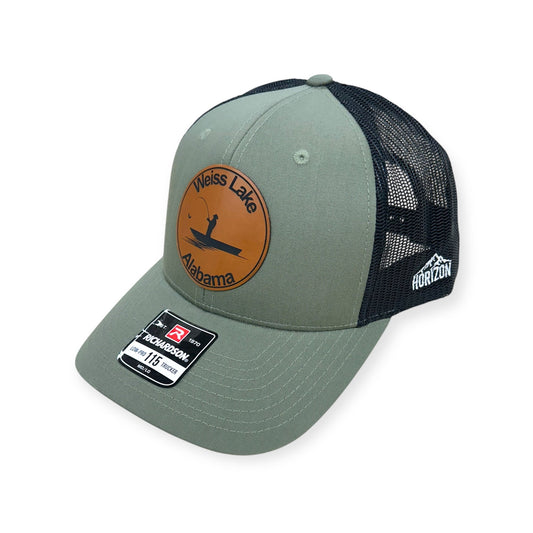 Angled view of Weiss Lake patch hat by Horizon Hat Co. in loden/black showing the curved bill and side panels