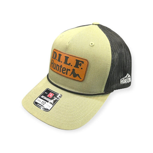 Angled view of DILF Hunter patch hat by Horizon Hat Co. in loden/black showing the bill and side panels