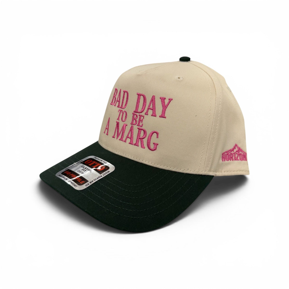 Angled view of Bad Day to Be a Marg embroidered cap by Horizon Hat Co. in natural/green showing the curved bill and side panels