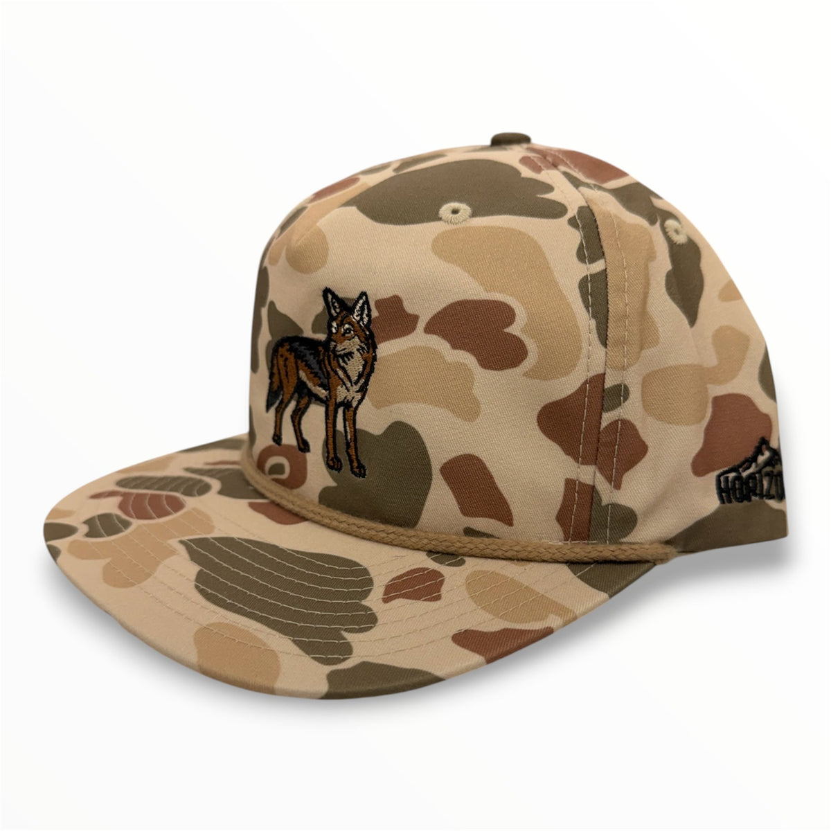Angled view of Coyote embroidered cap by Horizon Hat Co. in harvest duck camo showing the rope detail and side profile