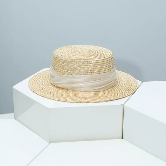 Black straw boater hat ribbon detail studio angle