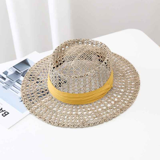 Open-weave linen sun hat with a yellow band, showing its airy texture