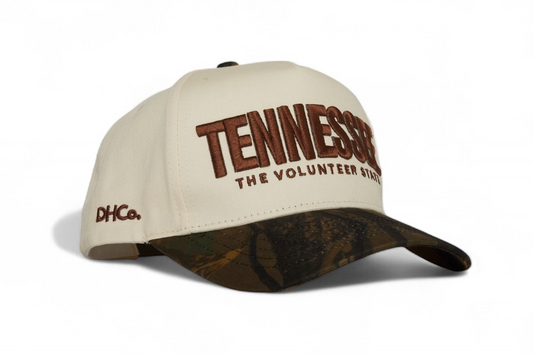 Destination Hat Co. Tennessee camo cap with beige crown and camouflage bill, angled view