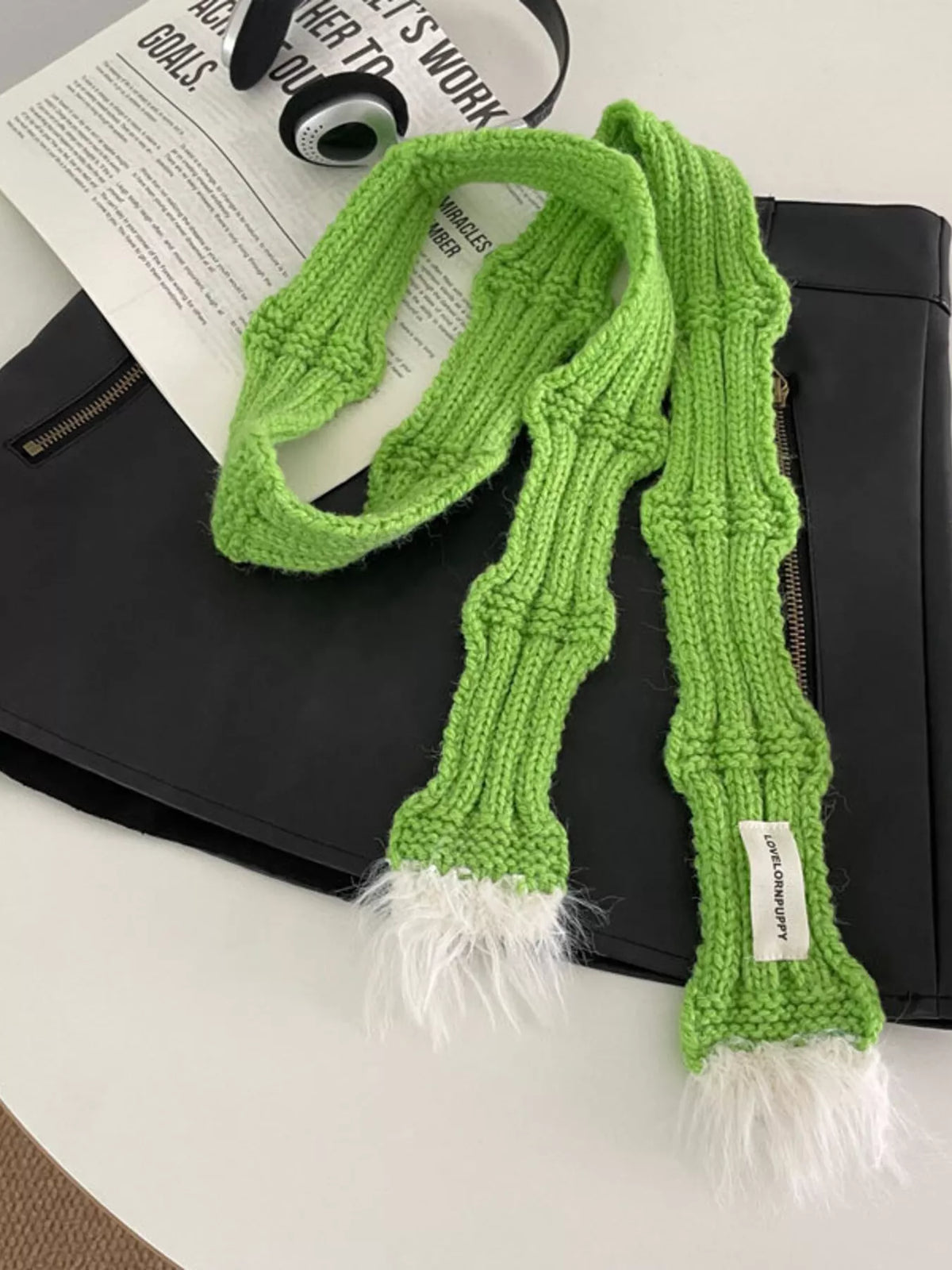 Unisex Plush-Tip Skinny Knit Scarf — green narrow scarf tied on a dark garment