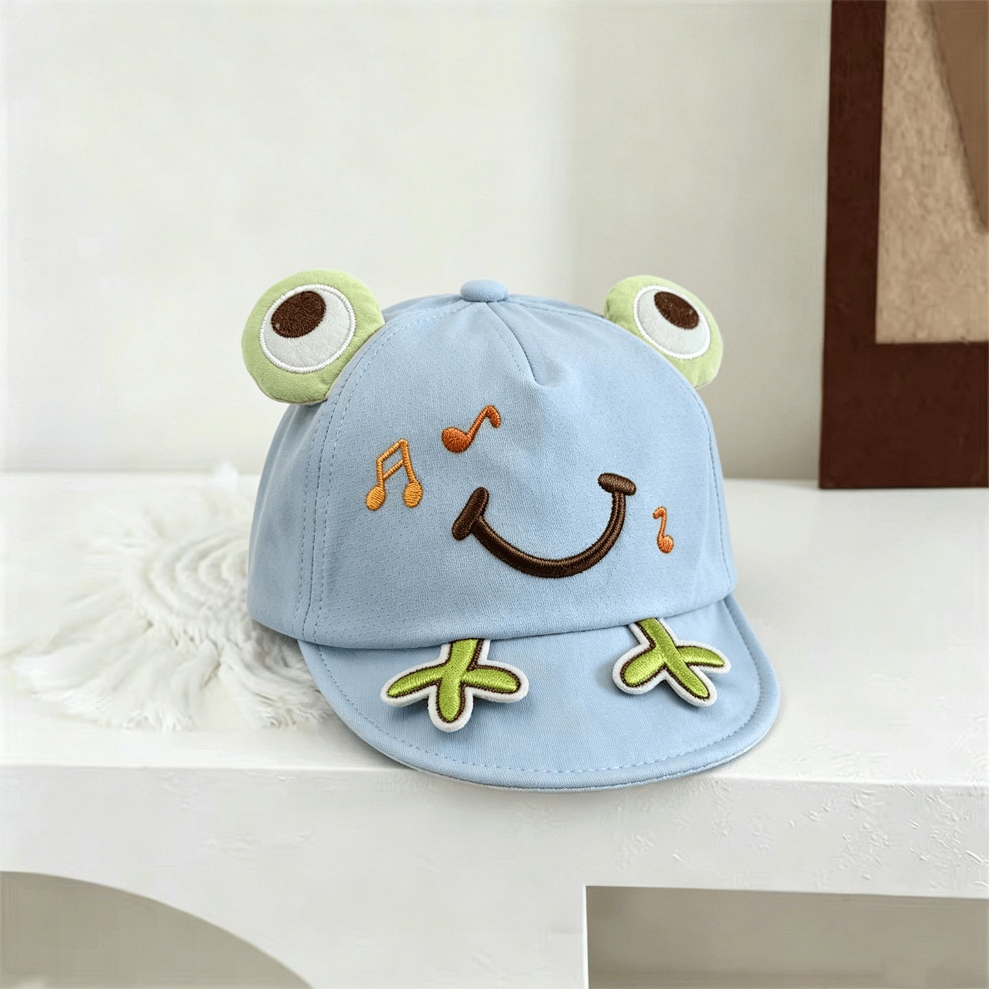 Pink embroidered frog baseball cap crown detail