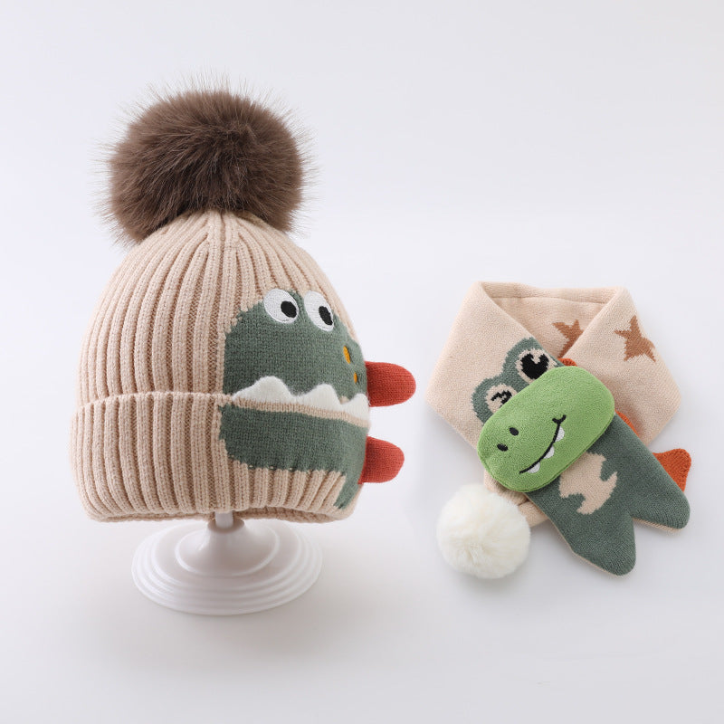 Beige dinosaur pom pom beanie and matching star-pattern scarf