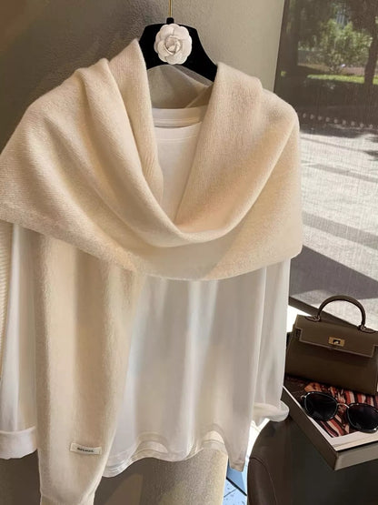 Women's Wool Knitted Asymmetrical Shawl — loose cream shoulder drape over a pale top