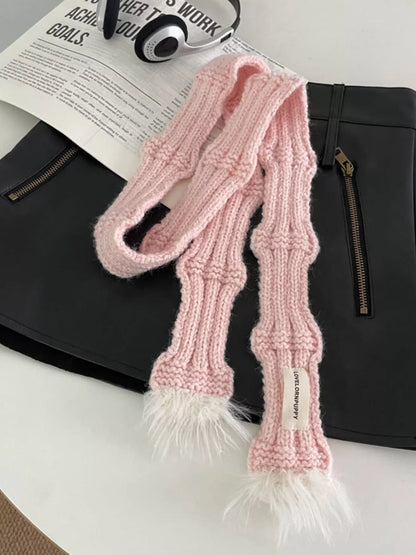 Unisex Plush-Tip Skinny Knit Scarf — pink narrow knit scarf laid across pale outerwear