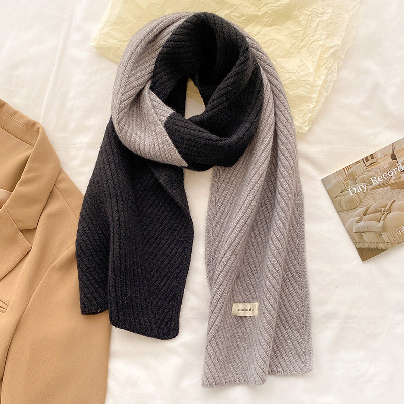 Unisex Two-Tone Ribbed Knit Winter Scarf — black and gray two-tone scarf draped over pale outerwear