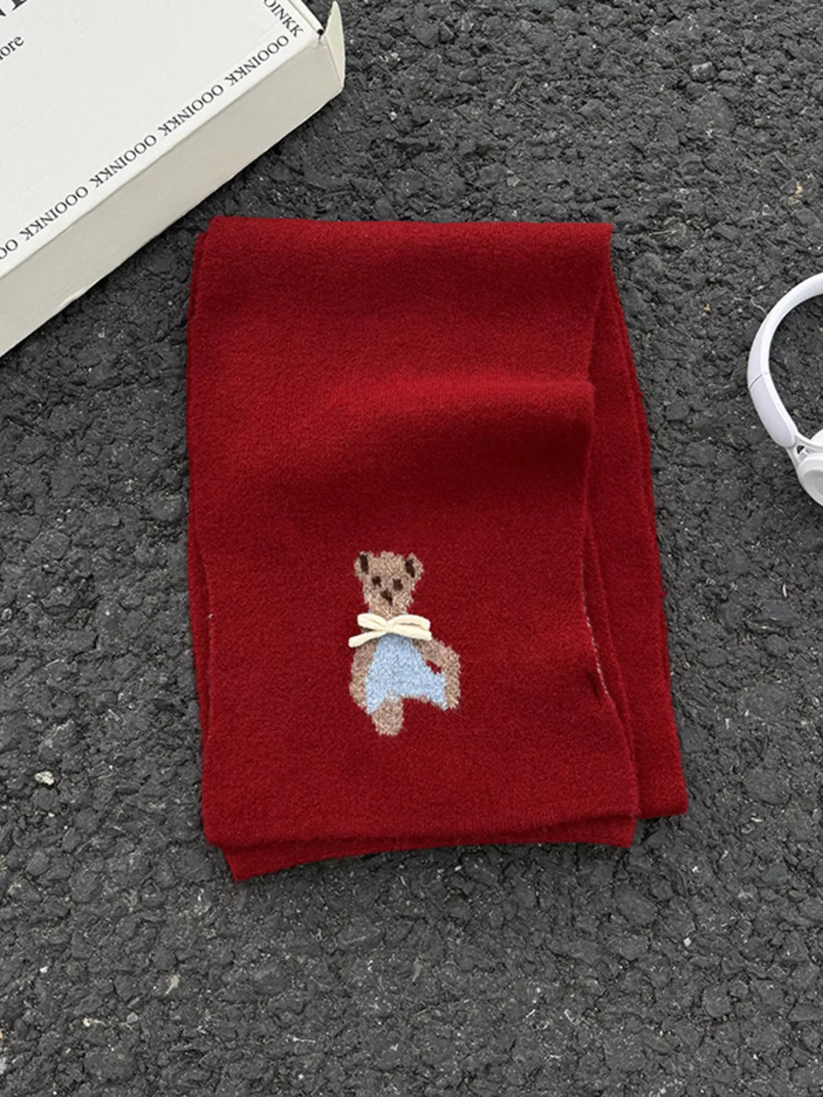 Unisex Bear Motif Knit Scarf — folded red knit scarf showing small bear detail