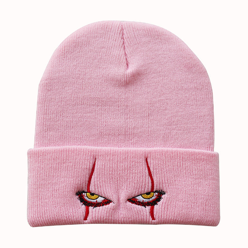 Pink creepy eyes knit beanie shown from the front