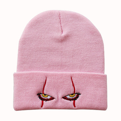 Pink creepy eyes knit beanie shown from the front