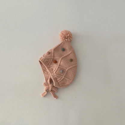 Pink cable-knit earflap hat with chin ties