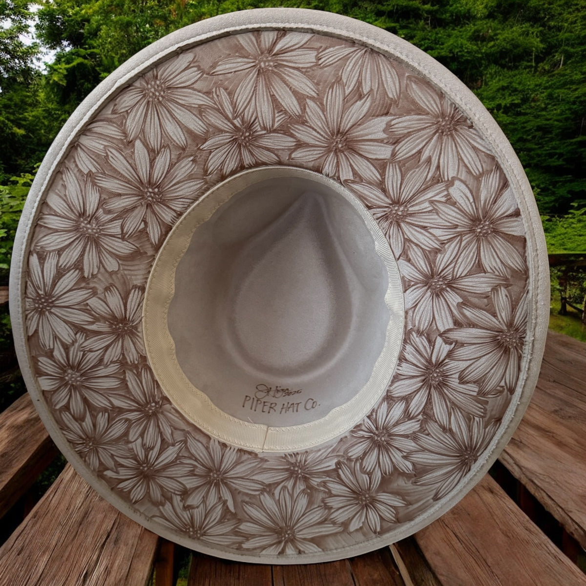 Underside of the ivory Playful Daisies brim covered in burned daisy artwork