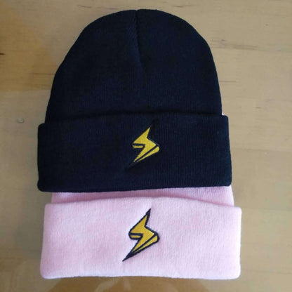 Black and pink lightning bolt embroidered beanies arranged together