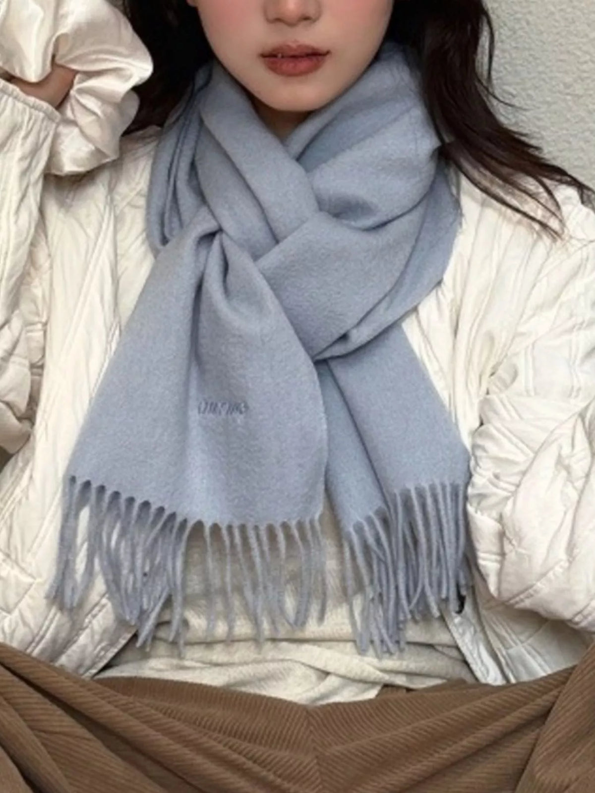 Unisex Azure Wool Fringe Scarf — azure scarf worn with light knitwear and a cream outer layer