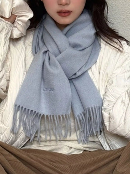 Unisex Azure Wool Fringe Scarf — azure scarf worn with light knitwear and a cream outer layer