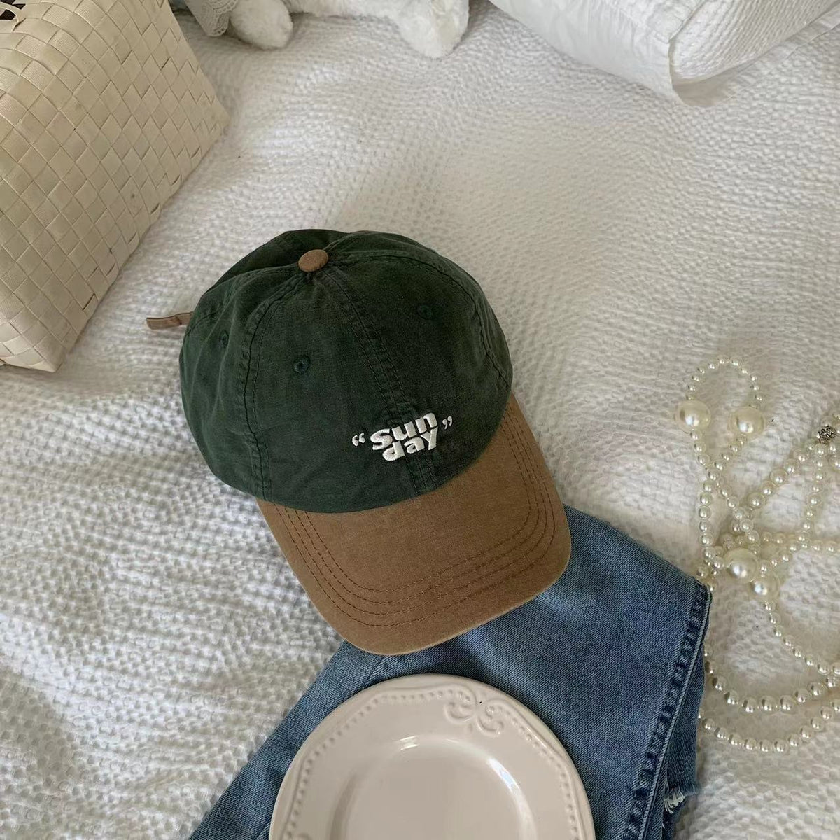 Green cotton baseball cap with a tan curved brim