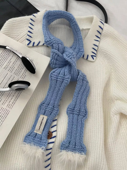 Unisex Plush-Tip Skinny Knit Scarf — blue skinny scarf tied over pale clothing