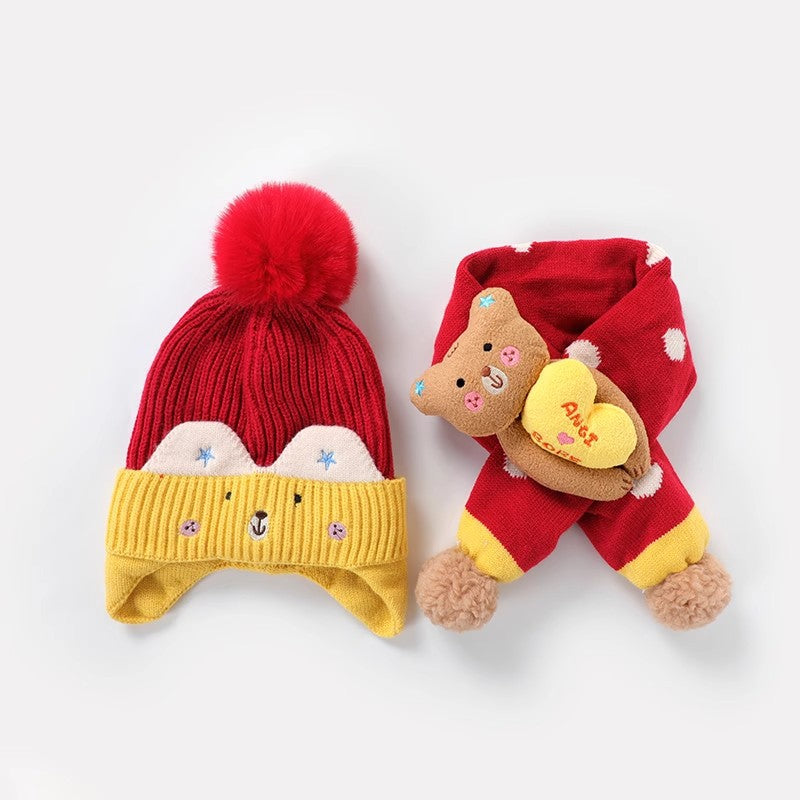 Red earflap beanie with yellow trim and a matching character scarf