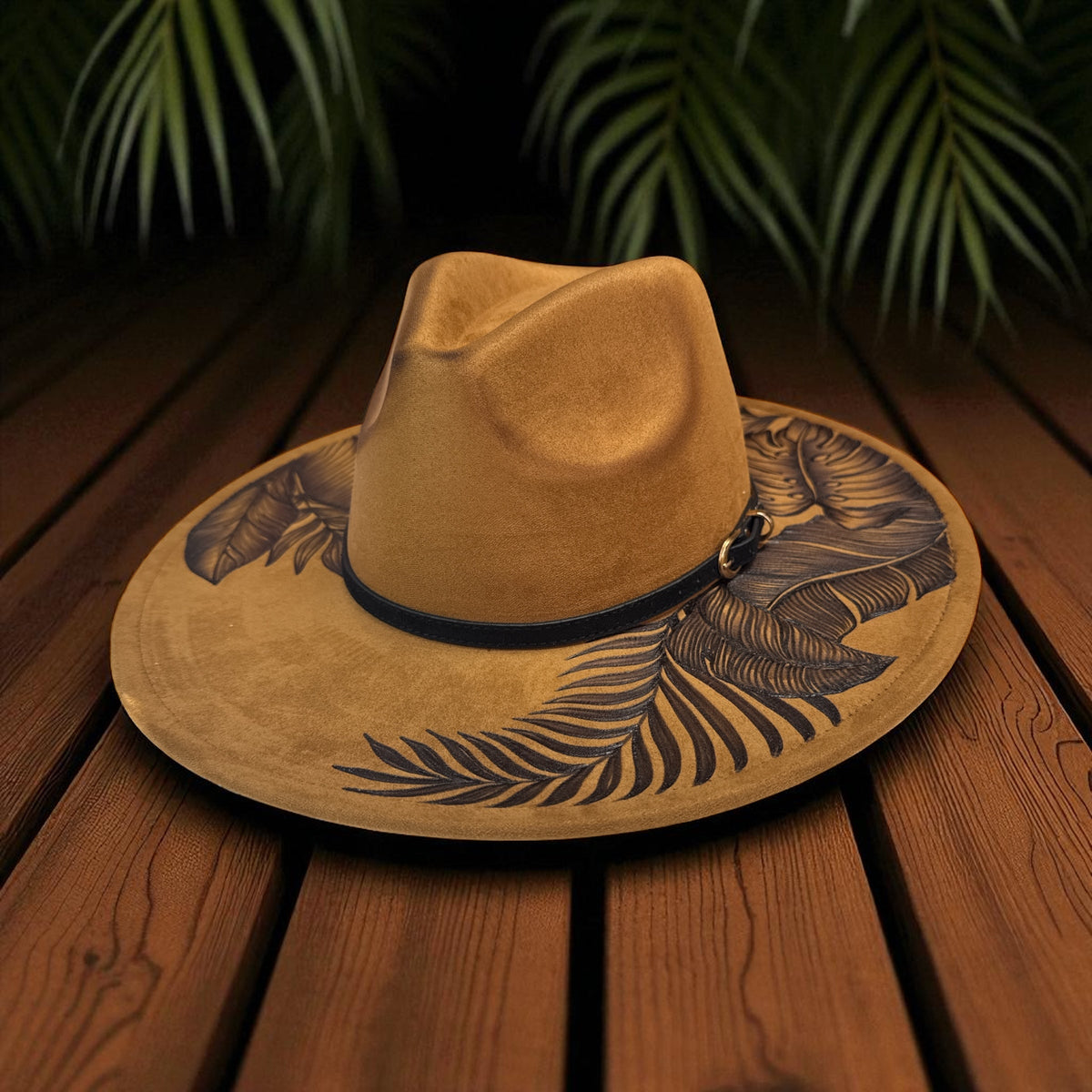 Khaki brown High Definition fedora on a wooden surface with leafy artwork visible