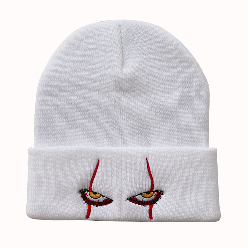 White cuffed beanie with red and black eye motif