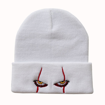 White cuffed beanie with red and black eye motif