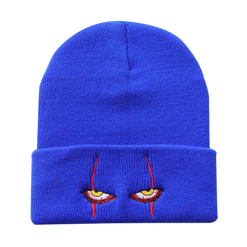 Blue knit beanie with narrow eyes and red embroidery