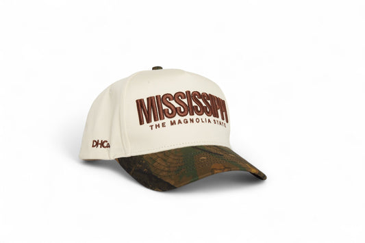 Destination Hat Co. Mississippi camo cap with beige crown and camouflage bill, angled view