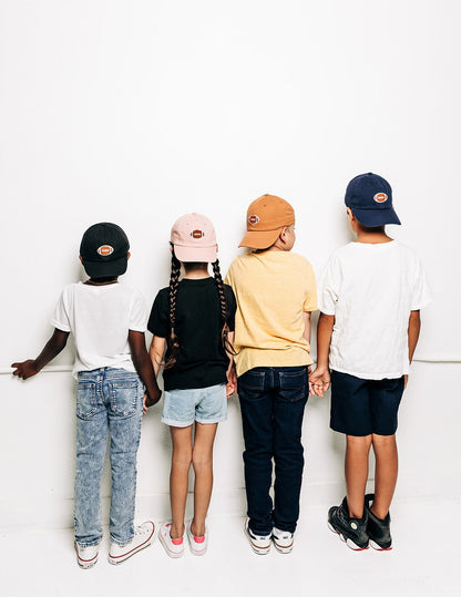 Rey To Z rear view of children wearing coordinated caps in several colors
