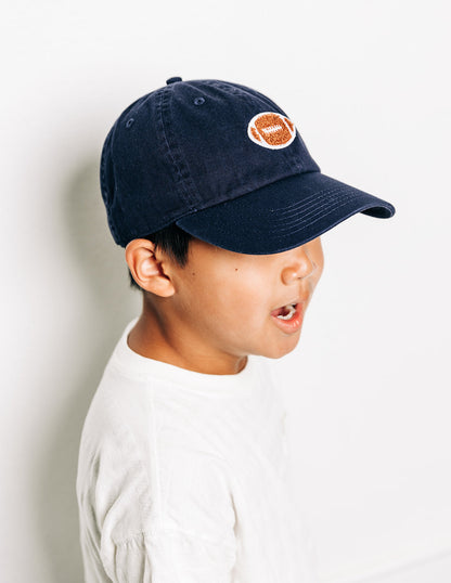 Rey To Z close side view of a child wearing the Navy football-patch cap