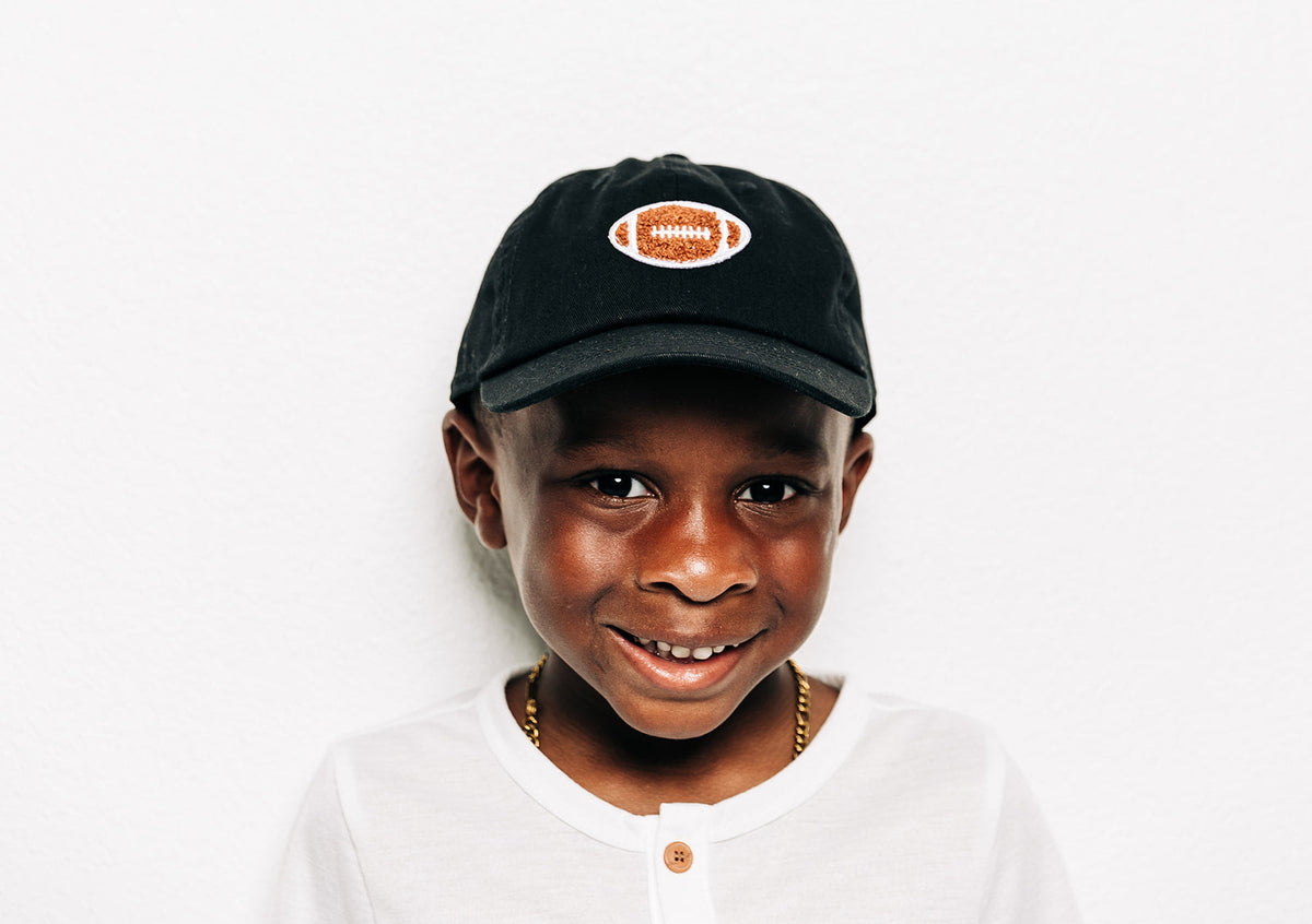 Rey To Z child wearing the Black football-patch cap