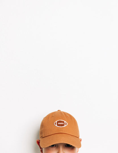 Rey To Z close view of the Terra Cotta football-patch cap worn by a child