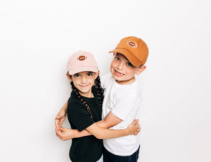 Rey To Z two children wearing Dusty Rose and Terra Cotta football-patch caps
