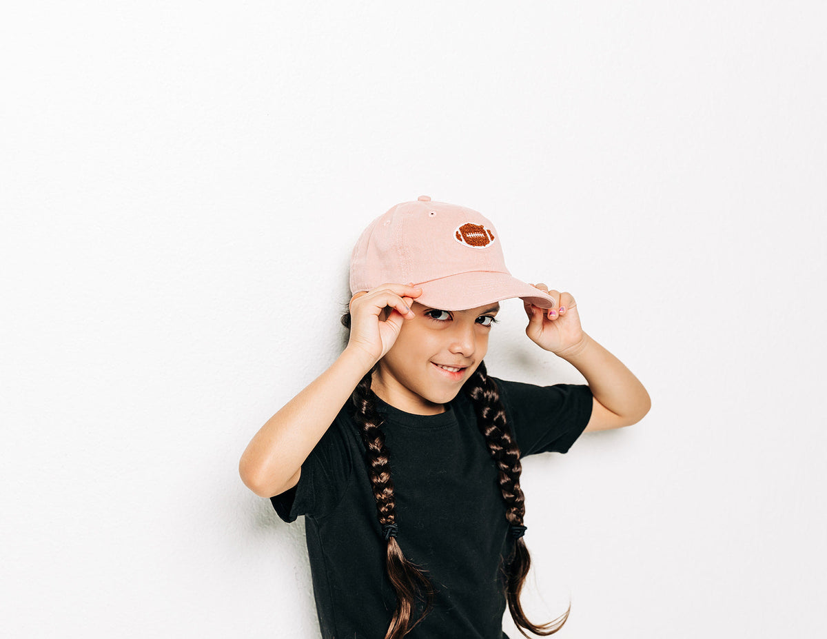 Rey To Z child wearing the Dusty Rose football-patch cap